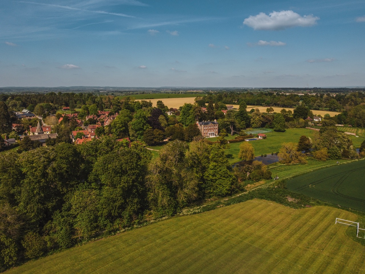 A countryside estate surrounded by fields and mature trees